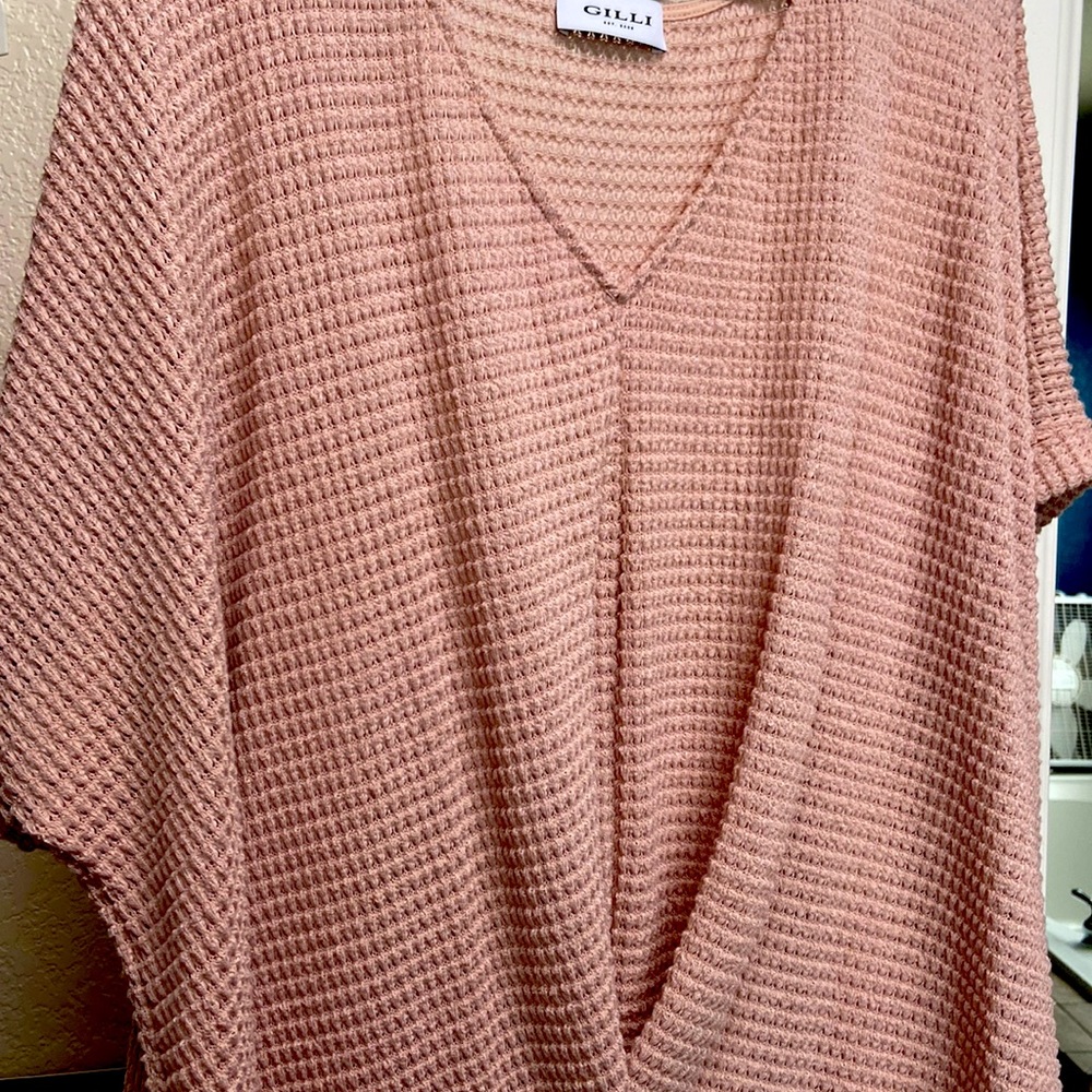 This is a very light tan sweater. It is a size 24 it has cap sleeves.